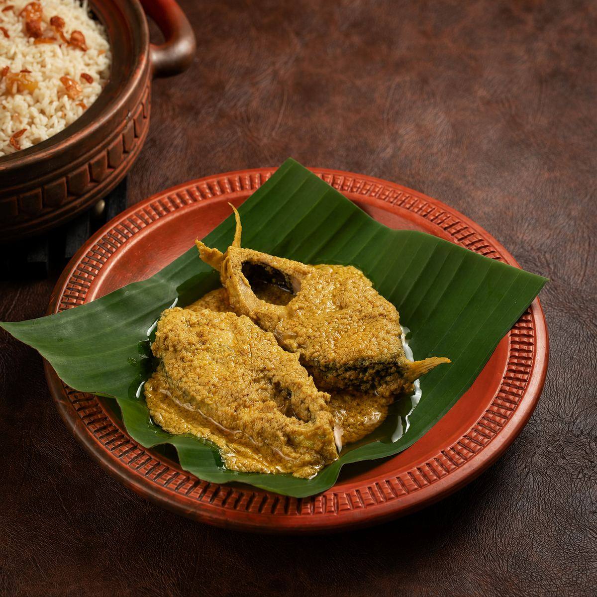 Sorisha Hilsa fish curry served on banana leaf